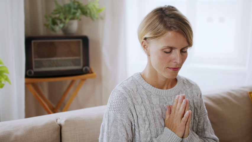 Portrait of woman indoors at home doing yoga, mental health and meditation concept.