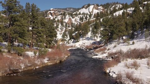 High definition drone aerial video flying over South Platte River in Colorado after fresh snowfall.