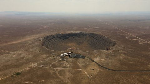 Cinematic aerial flyover of prehistoric impact crater in the Southwest desert
