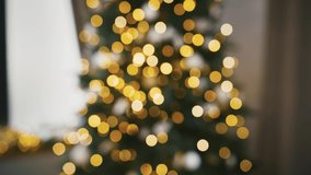 Hands of unknown people who cheering with glasses of champagne against Christmas tree decorated with glowing garland. Blurred background, bokeh. Happy New Year. Close up, slow motion - Powered by Shutterstock - Get 15% off with code: PIKWIZARD15