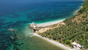 Aerial drone video of not so famous turquoise paradise beach of Armenopetra covered with pine trees, Skopelos island, Sporades, Greece