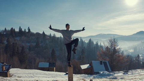 Aerial view, man practicing yoga on the background of winter mountains.