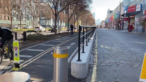 New York, NY, USA - Dec 8, 2020:  Dedicated bike lane showing bicyclists on the Hudson Greenway near Chelsea Piers on the west side of Manhattan