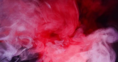 Whimsical movement of colored puffs of smoke against a dark background.