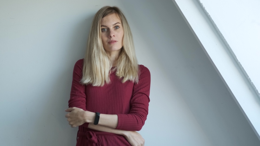 portrait of beautiful caucasian woman near white wall
