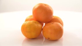 bright orange ripe tangerines rotate on their axis - Powered by Shutterstock - Get 15% off with code: PIKWIZARD15