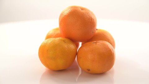 bright orange ripe tangerines rotate on their axis