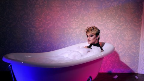 Relax transsexual woman take bath neon light. Make up queer female trans lgbt. Bathing froth bisexual man. Gay transvestite spa. Cosmetics foam homosexual trans. Gender transsexualism lgbtq people.