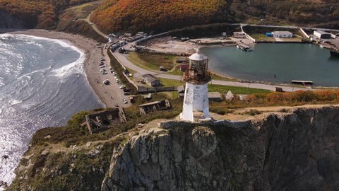 View from above. Panoramic shot of the Rudny lighthouse, which stands on a steep cliff ledge at Cape Briner. Lighthouse of the village of Rudnaya Pristan in the Primorsky region.