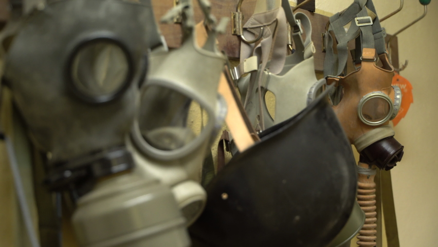 Old vintage gas masks hanging on a wall