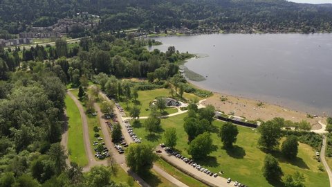 Aerial pan footage of Lake Sammamish State Park, Issaquah, Sunset Beach, Tibbets Beach, Newport, Montreux, the I-90 highway, Lake Sammamish and surrounding suburbs in King County, Washington