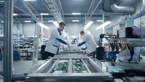 Modern High-Tech Electronics Factory Moving Manufacturing Conveyor: Professionals Doing Precision Work Assemble Circuit Boards, Processors, Microchips, Semiconductors. High-Quality Production Line - Powered by Shutterstock - Get 15% off with code: PIKWIZARD15