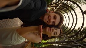 Pov shot of newlyweds man and woman having video call in park. Closeup happy couple informing about marriage outdoors. Brunette bride sending kisses on camera in vertical orientation - Powered by Shutterstock - Get 15% off with code: PIKWIZARD15