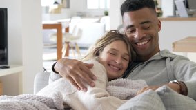 Mixed-raced couple relaxing in sofa, embracing each other  - Powered by Shutterstock - Get 15% off with code: PIKWIZARD15