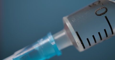 Close Up of Injection Liquid Being In Syringe Against Red Background. Medication Drug Needle Syringe Drug, Flu Shot Vaccine Vial Dose Hypodermic Injection Treatment Disease Prevention Immunization.