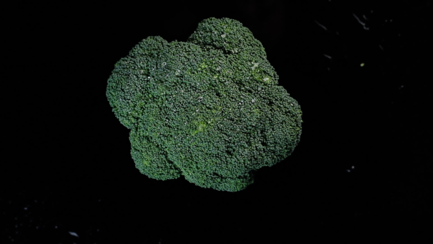 Fresh green broccoli rotating on a black background. Shopping, healthy eating concept. Top view. | Shutterstock HD Video #1063705573