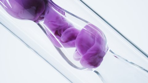 Pink liquid substance flows through a glass flask. Concept for advertising perfume and cosmetic products. Mixing pink ink with water in a large laboratory glass test tube.