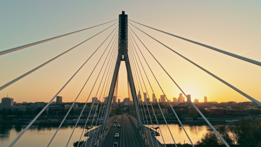 Aerial Geometry Pespective View of Suspension Bridge with Warsaw Skyline, capital of Poland (Warszawa, Polska). Urban Downtown Cityscape at Sunset. Tilt Background Drone view Video with Copy Space | Shutterstock HD Video #1063706470