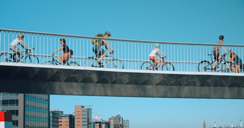 Busy cyclist bridge with bike lane in central Copenhagen or Amsterdam. European cycling capital city, move towards sustainability and green ecological future. COPENHAGEN, DENMARK - JULY 2020