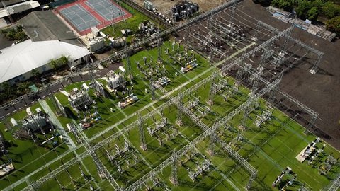 4K video from the drone of the electric transmission station with metal poles and electrical wires