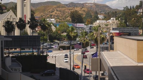 Los Angeles , CA , United States - 05 22 2019: Intersection of Highland Ave and Franklin with Hollywood sign far away and United Methodist Church left
