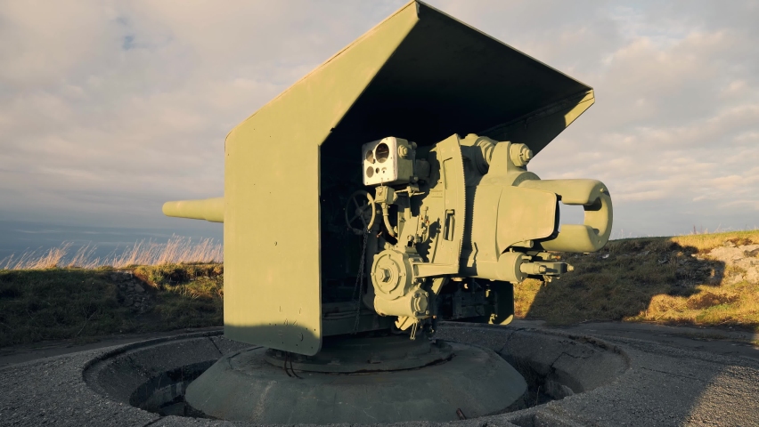 Beautiful close-up of an artillery cannon pointing towards the ocean.