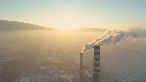 Aerial view of smoking chimney pipes. Air pollution by industrial smoke