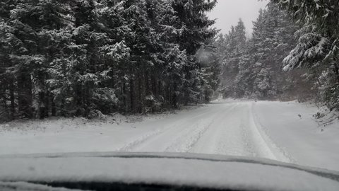 Driving car on a heavy snows road
