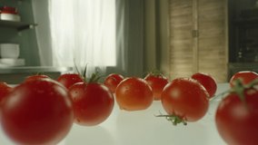 Dolly shot of the camera moves past a scarlet tomato to a sandwich