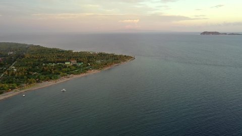 Aerial View Of Negros Oriental Island With Boats Sailing On Calm Ocean At Sunrise In Philippines - Apo Island By Sulu Sea.