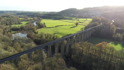 Old Welsh Pontcysyllte Aqueduct waterway aerial view rural Autumn woodlands valley wide orbit left