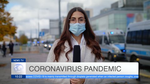 Caucasian Confident Young Woman Journalist In Protective Mask With Microphone Presenting Breaking News TV About Coronavirus Pandemic On Street Outdoors Cars On Signals Police In Background