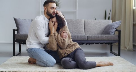 Caring husband caucasian male boyfriend consoles crying african american woman wife girlfriend support hugs. Girl feels sadness upset stress suffers from breaking up quarrel, family couple concept