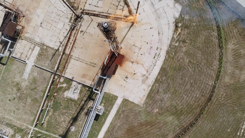A tower for flaring associated gas at a petrochemical plant. Fiery torch. Aerial view
