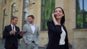 Business woman speaking mobile phone onthe go to office outdoors. Smiling business people using digital devices while walking on city street. Corporate people rushing to work outside. - Powered by Shutterstock - Get 15% off with code: PIKWIZARD15