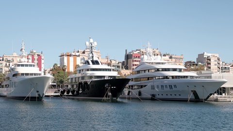 Footage of luxury yachts and boats docked in port vell harbour, barcelona spain, 