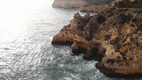 Atlantic Ocean waves washing on rock cliffs. Carvoeiro coastline , Algarve.