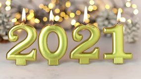 Burning gold candles with the numbers 2021 on a holiday winter background. Festive New Year's Eve. Concept for the beginning of the New Year. Short version. Close-up 