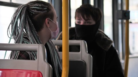 Prague , Czech Republic - 11 11 2020: Female Passengers With Face Masks Sitting and Talking in Tram During Covid-19 Virus Global Outbreak, Slow Motion