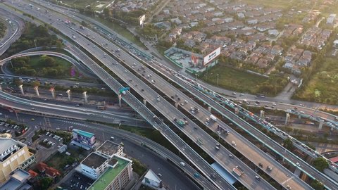 Aerial top View of busy freeway, rush hour heavy traffic jam highway. Aerial view of multiple roads in city, vehicular intersection, expressway with important infrastructure in the morning.