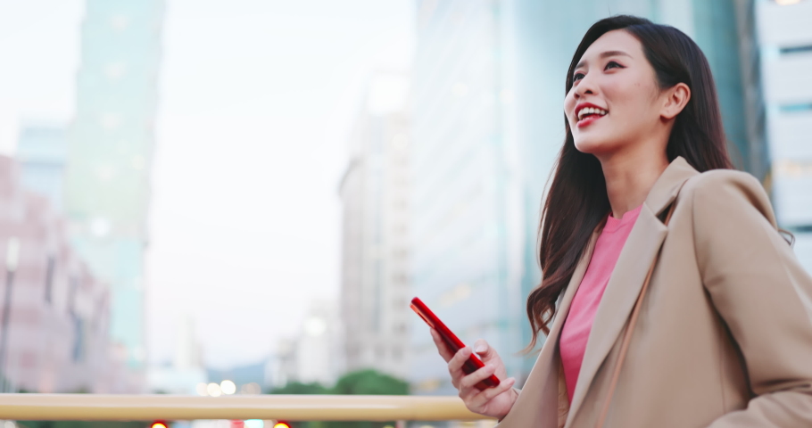 asian woman use smartphone outdoor while commuting happily Royalty-Free Stock Footage #1063756339