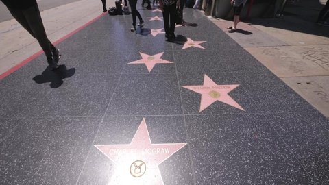 Los Angeles , CA , United States - 05 22 2019: Walk of fame actor stars in Hollywood Blvd. stepped on by pedestrians near Highland