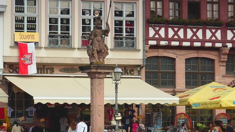 FRANKFURT, GERMANY - circa 2019: Frankfurt Old City, People Tourists Walk Visit Romerberg Square Romerplatz, footage cleaned up with video denoiser.