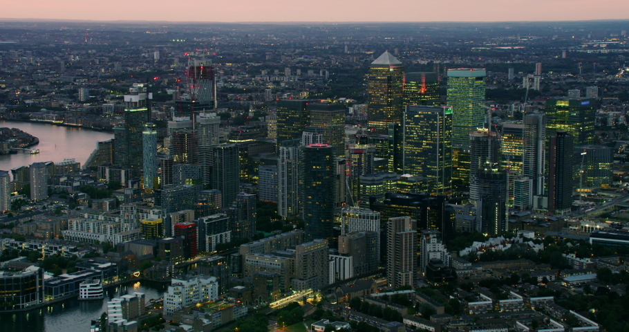 Augmented reality elements over London Financial District with economic charts and data. Futuristic aerial skyline of London with stock exchange figures. Representing concepts as Big data, AI, IOT. Royalty-Free Stock Footage #1063770331