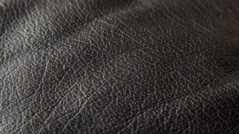 Black leather texture close up extreme close up sliding camera move stock footage