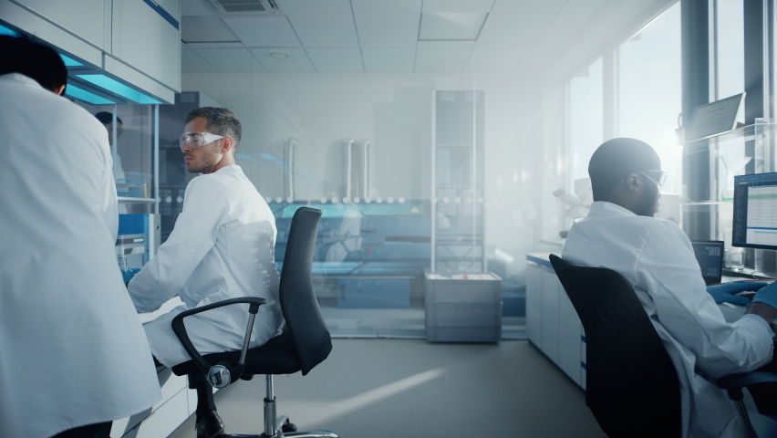 Medical Science Laboratory with Diverse Multi-Ethnic Team of Scientists Developing Drugs, Medicine, Doing Biotechnology Research. Working on Computer, Using Microscope, Analysing Samples. Slow Motion | Shutterstock HD Video #1063773241