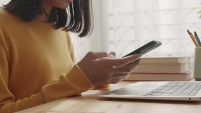 Side view. Hand of Asian girl using texting mobile phone or chat in home morning and sunlight. Close up of young woman hand - Powered by Shutterstock - Get 15% off with code: PIKWIZARD15