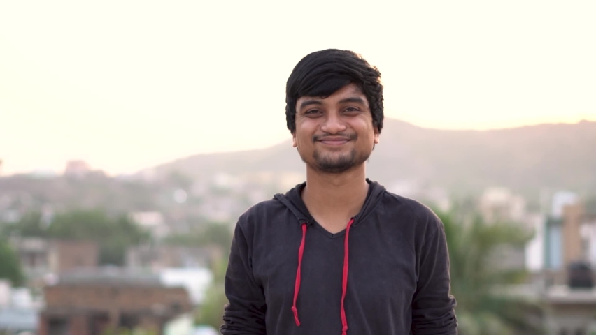 Portrait of an Indian man smiling while staring at the camera | Shutterstock HD Video #1063778833