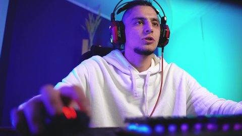 The gamer speaks through a headset with a microphone with partners and plays