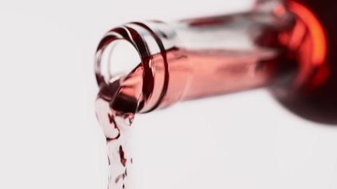 Pouring Rose Wine from a Transparent Bottle on the White Background in 1000fps (Phantom Flex)